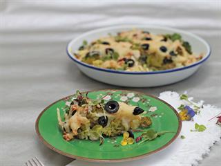 Oven-baked cauliflower, broccoli, olives and cheese