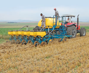 The 6-row SL precision planter operating in fresh wheat stubble.