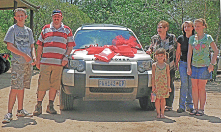 My son, his family and my wife with the beribboned Freelander. Grandson Tiaan (extreme left), now in Grade 9, meticulously rebuilt the vehicle in his spare time. Beside him is his father Jac, my wife Aneta (with wrap-around smile), daughter-in-law Ronel and their two daughters, little Karien and Lise. Photo courtesy of Abre' J.Steyn